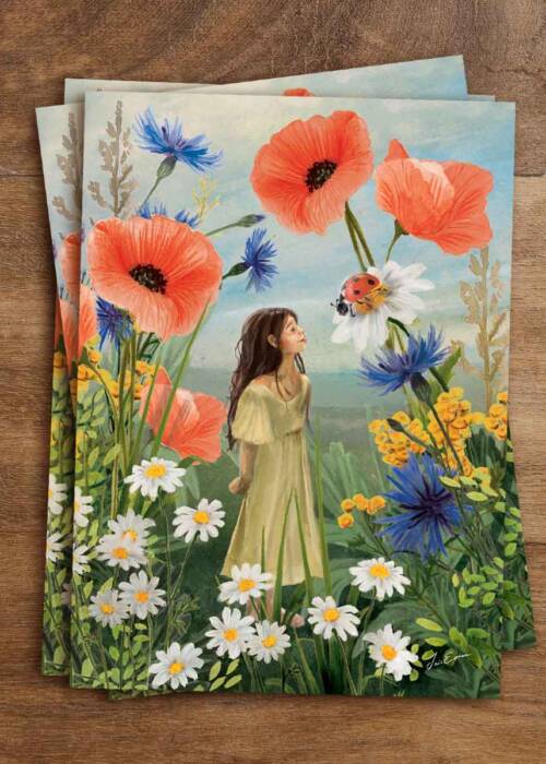 postcard of a young girl in a field of wild flowers