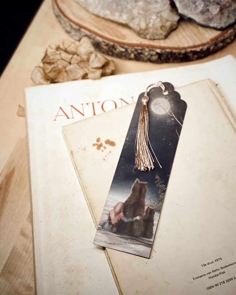Winter-themed bookmark featuring a girl and two bears gazing at a glowing moon in a snowy forest.