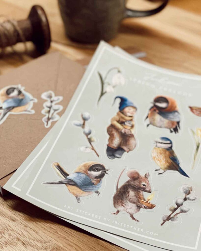 Whimsical spring stickers with a mouse holding a candle, pussy willow branches, birds in scarves, and a smiling child in a blue gnome hat.