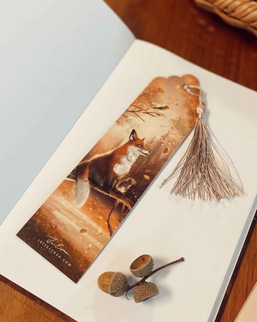 bookmark with a fox, hedgehog and two mice watching autumn leaves dance